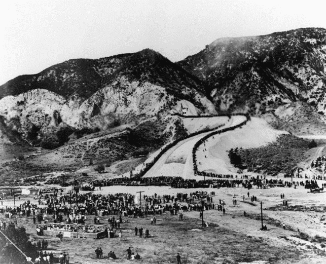 Crowds cheer as Owens River water cascades down the channel into the Valley for the first time.*