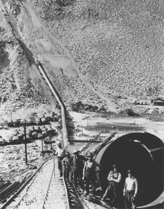 (ca. 1912)* - A view of workmen posing in front of a new section of the aqueduct pipeline.