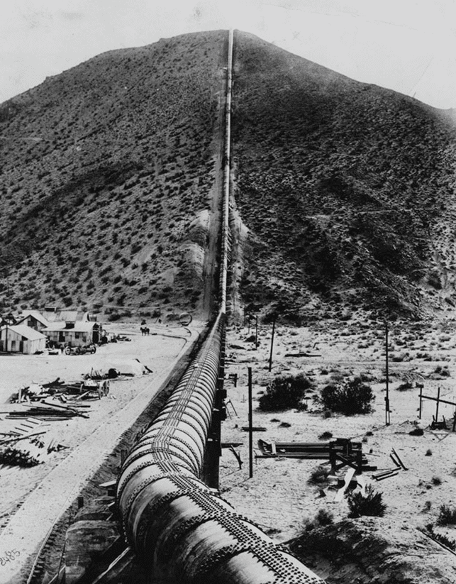 (ca. 1912)* - Caption reads: The famous Jawbone siphon of the Los Angeles Owens River aqueduct, built by William Mulholland, which crosses two mountain ranges and the Mojave Desert to bring the city its water supply from the snow-capped High Sierras--a 250-mile journey.