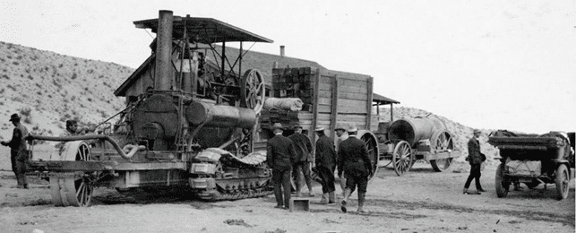 (1908)^#^ - Caterpillar Traction Engine hauling lumber on the Mojave Desert.