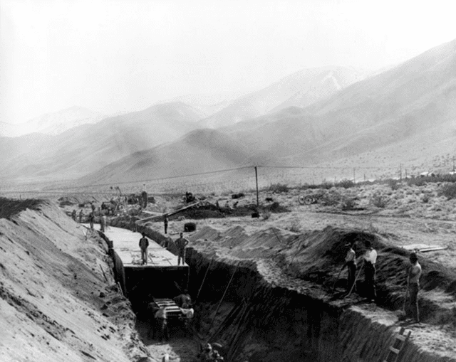(ca. 1910)^^^ - Forms for cement lining are being put in place at an open channel section of the LA Aqueduct.
