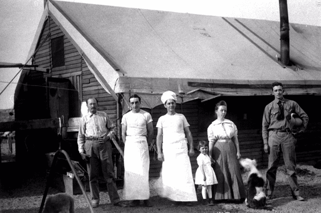(ca. 1912)^*– View showing some of the cooks and possibly family posing in front of the mess hall.