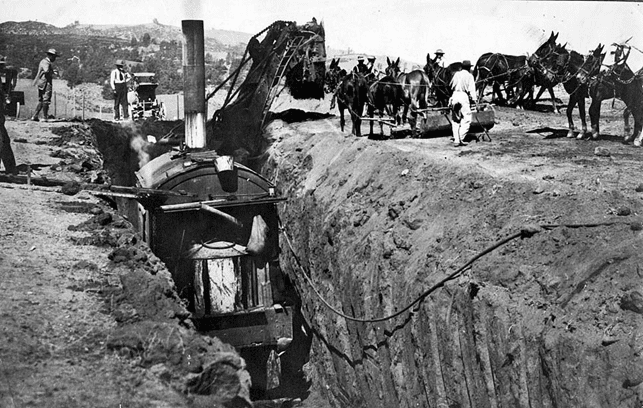 (ca. 1911)*# - Men in steam shovels work in conjunction with mule teams during the excavation process.