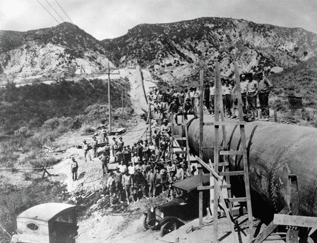 (ca. 1912)* - A view of the workmen on the aqueduct pipeline. Power lines can be seen on the left.