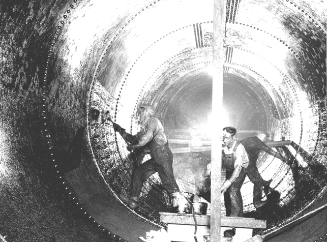 (n.d.)#* - Workers prepare aqueduct pipe.