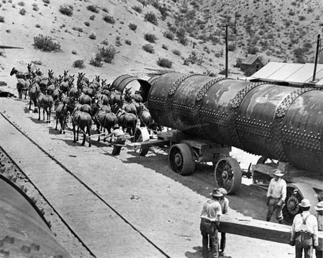 (1912)# - A 52-mule team, six abreast at the wheel, transporting a 30-ton section of steel pipe during construction of the Jawbone Siphon.