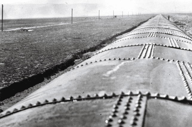 (ca. 1913)*^ - Close-up view of the longest section of steel pipe along the aqueduct in Antelope Valley.