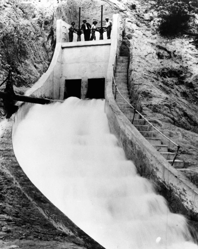 (October 16, 1913)* - The gates are opened to allow water to cascade down above the San Fernando dam during a dual test and photo opportunity for the new Los Angeles Aqueduct before the opening ceremonies.